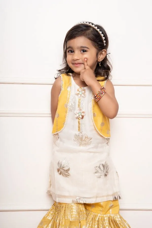 Charming ivory and yellow sharara set with delicate silver floral embroidery and playful appliqués