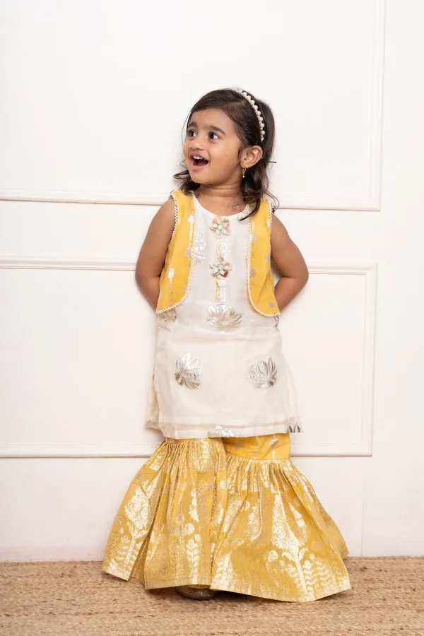 Charming ivory and yellow sharara set with delicate silver floral embroidery and playful appliqués